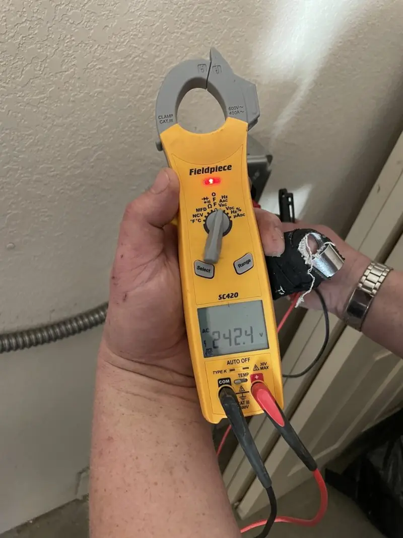 Voltage testing with clamp meter during Recessed Lighting Installation in Belton